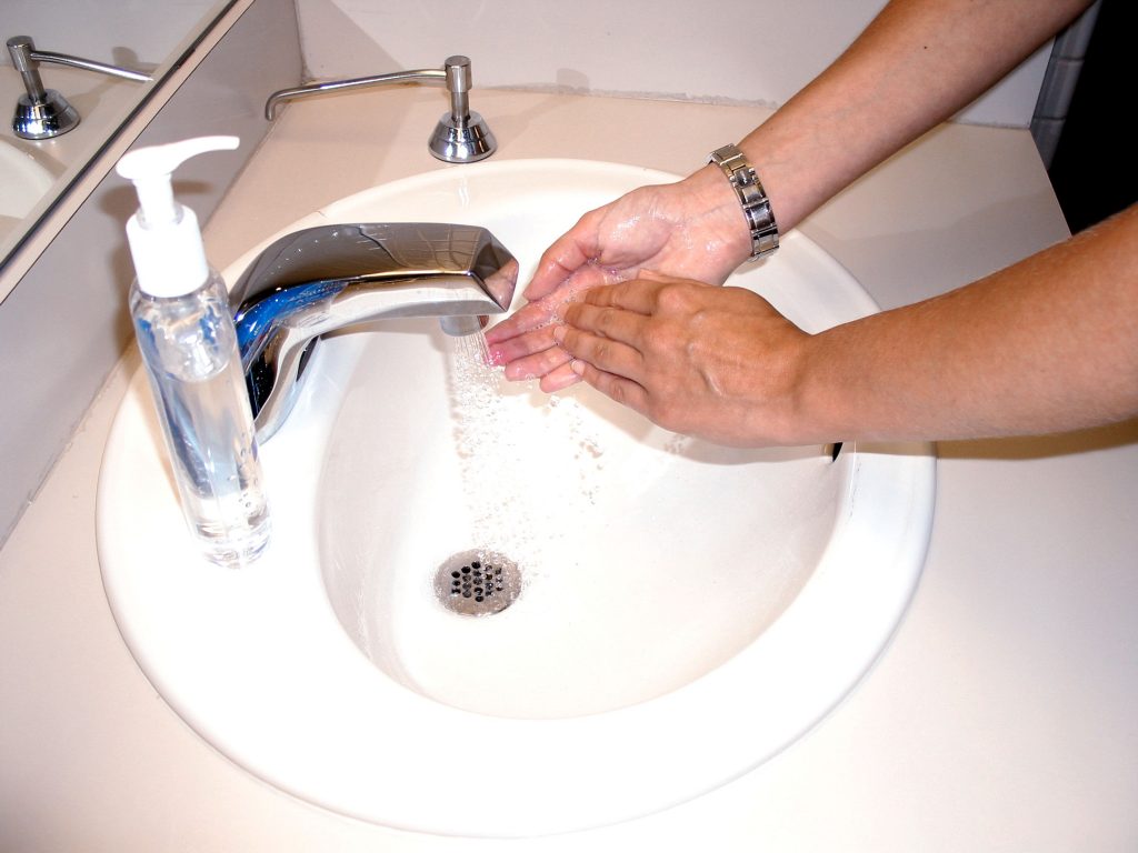 Washing hands with soap and water or an alcohol scrub